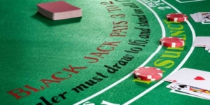 cards laying on a green blackjack table cards laying on a green blackjack table