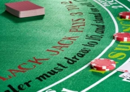 cards laying on a green blackjack table